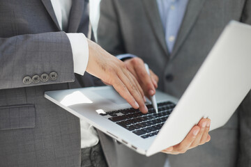 discussion between two businessmen looking at the laptop