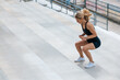 © zinkevych - Blonde woman in sportswear jumping on the stairs