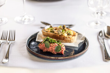 Wall Mural - Steak Tartare with bread toasts served on a restaurant table