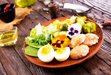 Poster - Fried salmon cutlets on a plate with vegetables and boiled eggs