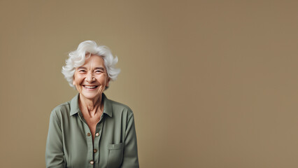 Wall Mural - Beautiful old woman smiling isolated on studio background. Copyspace area