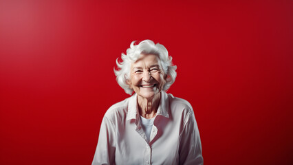 Wall Mural - Beautiful old woman smiling isolated on studio background. Copyspace area