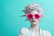 Portrait of a lady in the image of the statue of liberty wearing pink sunglasses on a blue background.