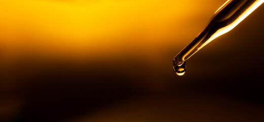 Wall Mural - yellow science test tube,dropping yellow chemical liquid or essential oil to test tube on white back