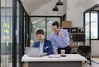 © ArLawKa - Two Asian businessmen raising their hands to celebrate success, rejoicing in increasing profits in business are getting good news online.