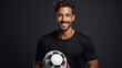 Portrait of a soccer player, handsome young man with ball, Sports man, soccer field training with a soccer ball, happy and relax before fitness workout. Copy space