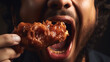 man eating a takeaway fried chicken wing from fast food cafe with a mouth and teeth close up