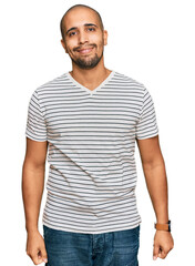 Canvas Print - Hispanic adult man wearing casual clothes relaxed with serious expression on face. simple and natural looking at the camera.