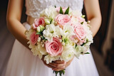 Fototapeta Kwiaty - The bride holds a beautiful wedding bouquet of pink and white flowers in her hands
