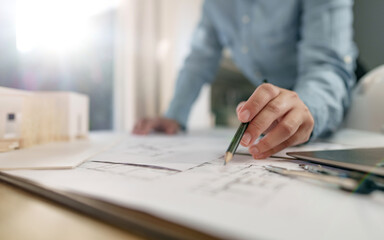 Fototapete - Architects interior designer hands working with Blue prints and documents for a home renovation for house design.