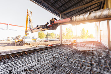 Wall Mural - Pipe of Concrete pump working on construction building site, sunlight