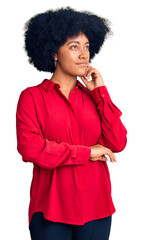 Wall Mural - Young african american girl wearing casual clothes with hand on chin thinking about question, pensive expression. smiling and thoughtful face. doubt concept.