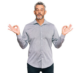 Wall Mural - Middle age grey-haired man wearing casual clothes relax and smiling with eyes closed doing meditation gesture with fingers. yoga concept.