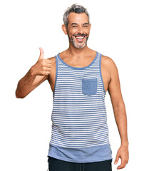 Poster - Middle age grey-haired man wearing casual style with sleeveless shirt smiling happy and positive, thumb up doing excellent and approval sign