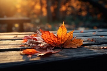 Poster - A detailed view of a single leaf resting on a wooden table. Perfect for nature-themed designs or projects