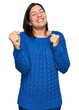© Krakenimages.com - Young hispanic woman wearing casual clothes excited for success with arms raised and eyes closed celebrating victory smiling. winner concept.