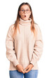 © Krakenimages.com - Beautiful caucasian woman wearing wool winter sweater scared and amazed with open mouth for surprise, disbelief face