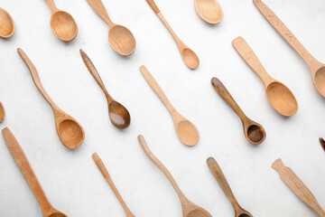 Wall Mural - Different stylish wooden spoons on light background