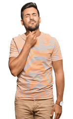 Sticker - Handsome hispanic man wearing casual clothes touching painful neck, sore throat for flu, clod and infection