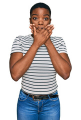 Poster - Young african american woman wearing casual clothes shocked covering mouth with hands for mistake. secret concept.