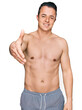 © Krakenimages.com - Handsome young man wearing swimwear shirtless smiling friendly offering handshake as greeting and welcoming. successful business.
