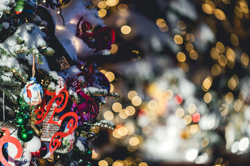 Wall Mural - Close up of balls on christmas tree. Bokeh garlands in the background. New Year concept. Christmas and New years eve Background. selective focus