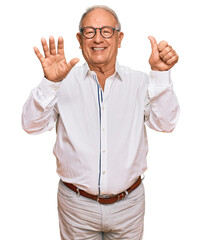 Wall Mural - Senior caucasian man wearing business shirt and glasses showing and pointing up with fingers number six while smiling confident and happy.