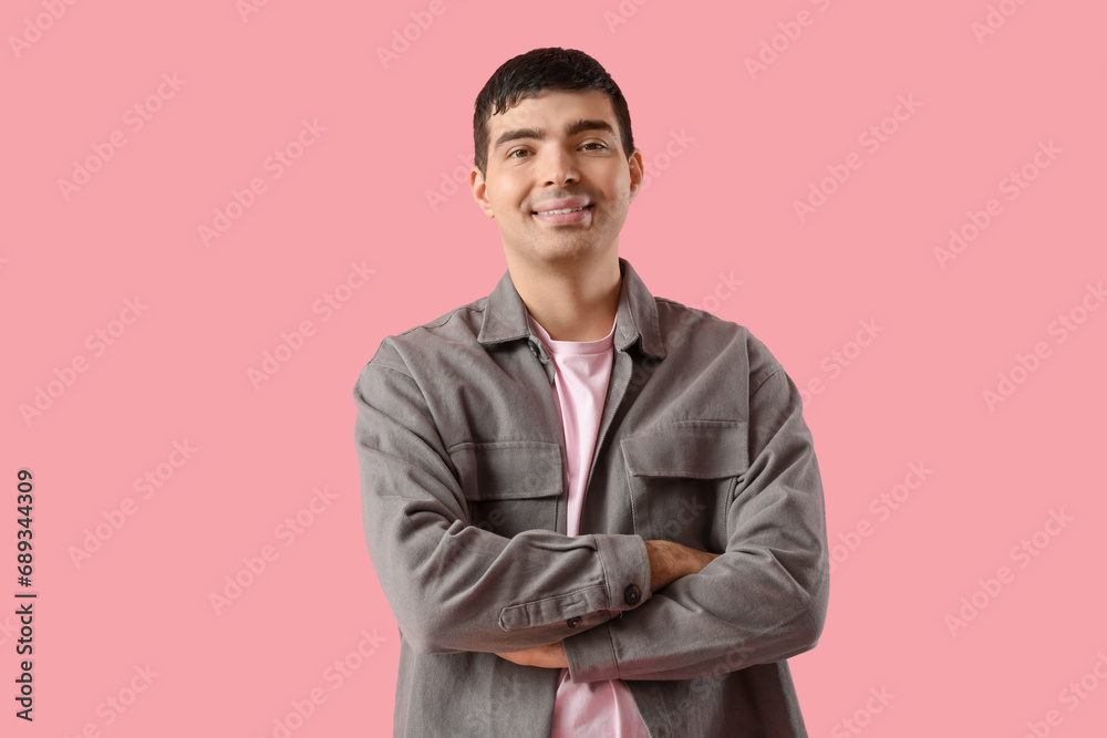 Happy young man on pink background