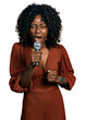 African woman with curly hair singing song using microphone angry and mad raising fist frustrated and furious while shouting with anger. rage and aggressive concept.