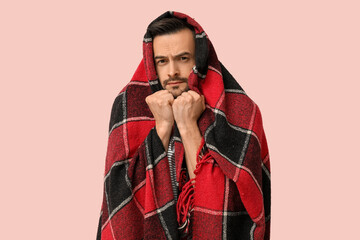 Poster - Sick young man with plaid on pink background