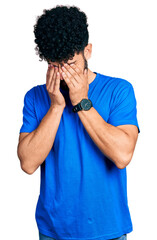 Wall Mural - Young arab man with beard wearing casual blue t shirt rubbing eyes for fatigue and headache, sleepy and tired expression. vision problem