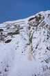 Snow avalanche. Mass of snow, ice, and debris fallen down a mountainside.