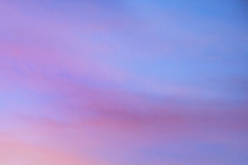 Wall Mural - sky with soft and fluffy pastel orange pink and blue colored clouds. sunset background. nature. sunr