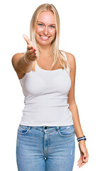 Canvas Print - Young blonde girl wearing casual style with sleeveless shirt smiling cheerful offering palm hand giving assistance and acceptance.