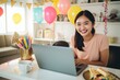 © Jorge Ferreiro - young asian woman celebrating joyfully and using her laptop