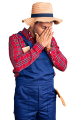 Sticker - Handsome latin american young man weaing handyman uniform with sad expression covering face with hands while crying. depression concept.