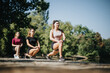 © qunica.com - Active females in a city park, enjoying outdoor training and stretching exercises. Friends staying fit, healthy, and happy in the natural environment.