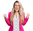 © Krakenimages.com - Young blonde woman wearing business style and glasses celebrating surprised and amazed for success with arms raised and open eyes. winner concept.