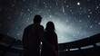 A couple gazing at the stars inside a planetarium.
