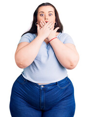 Wall Mural - Young plus size woman wearing casual clothes shocked covering mouth with hands for mistake. secret concept.