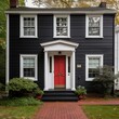 Black trim windows and red front door on white house
