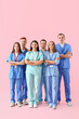 © Pixel-Shot - Group of medical students on pink background