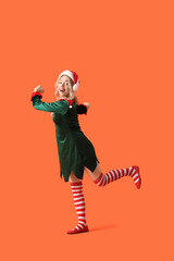 Sticker - Happy young woman dressed as elf on orange background