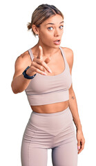 Wall Mural - Beautiful caucasian woman wearing sportswear pointing displeased and frustrated to the camera, angry and furious with you