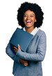 © Krakenimages.com - Young african american woman working using computer laptop smiling and laughing hard out loud because funny crazy joke.