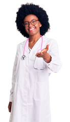 Poster - Young african american woman wearing doctor coat and stethoscope smiling cheerful offering palm hand giving assistance and acceptance.