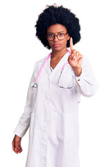 Sticker - Young african american woman wearing doctor coat and stethoscope pointing with finger up and angry expression, showing no gesture