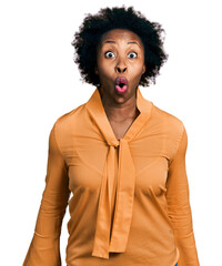 Poster - African american woman with afro hair wearing elegant shirt scared and amazed with open mouth for surprise, disbelief face