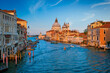 Panorama of Venice Grand Canal with boats and Santa Maria della Salute church on sunset from Ponte dell'Accademia bridge. Venice, Italy