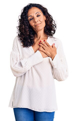 Canvas Print - Middle age beautiful woman wearing casual sweater smiling with hands on chest with closed eyes and grateful gesture on face. health concept.